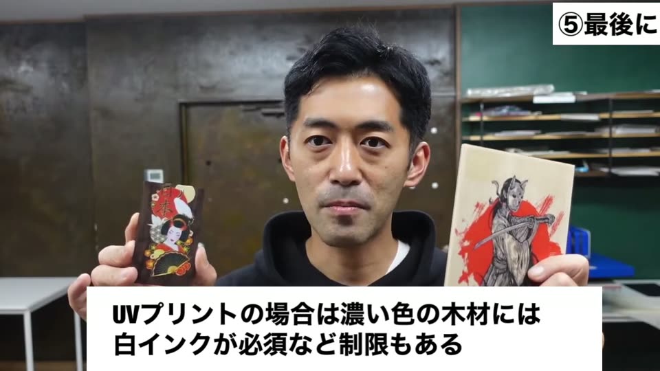 芸者のイラストを転写した濃い木片と、侍のイラストを転写した合板を両手に持って説明している。UVプリントの場合は濃い色の木材には白インクが必須など制限もあるというテロップ